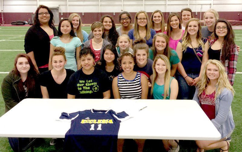 Submitted Photo Dahlia Mendoza and her mother pose with Dahlia&#8217;s soccer teammates on April 8 after she signed to play soccer next year for Ecclesia College.