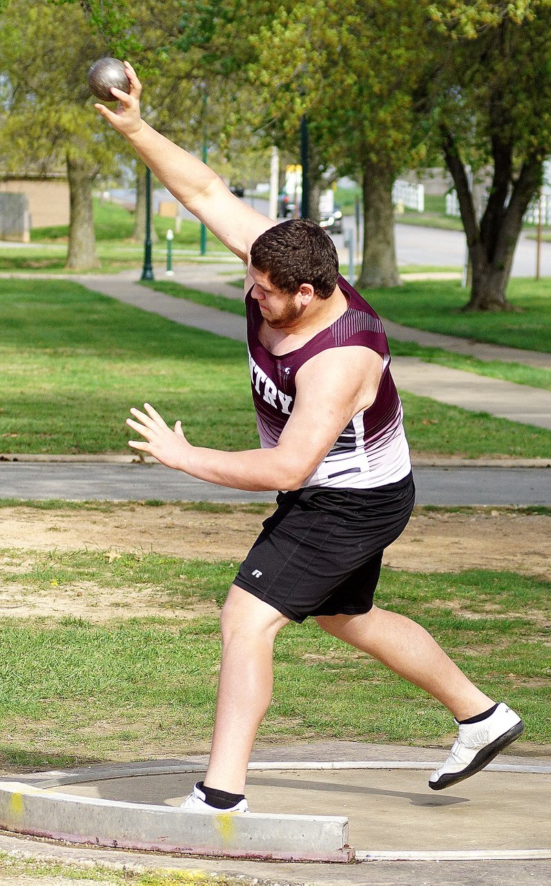 Photo by Randy Moll Zach Ellis, Gentry senior, throws the shot during competition in Siloam Springs on Thursday.