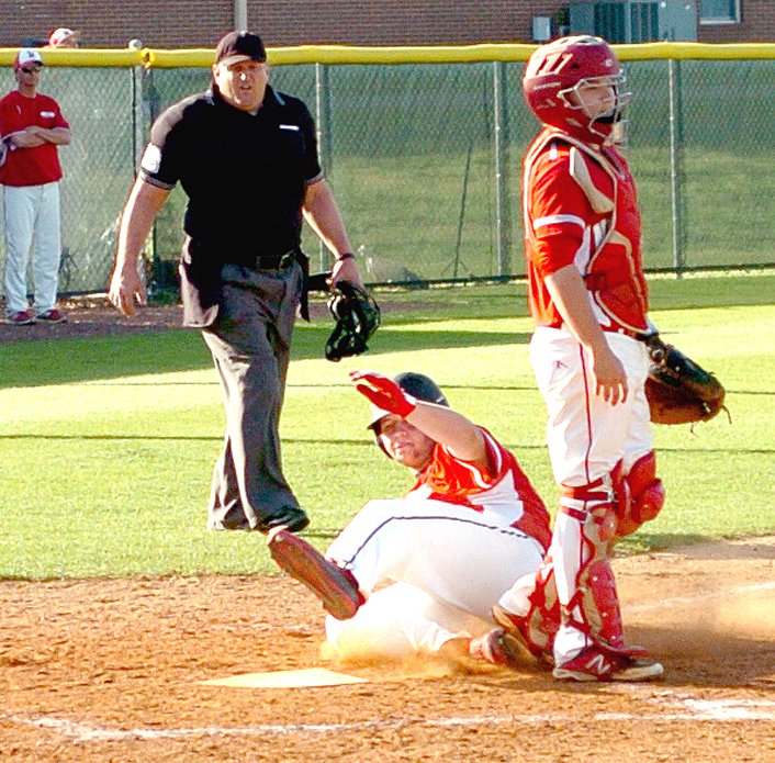 MARK HUMPHREY ENTERPRISE-LEADER Farmington senior first baseman Hayden Sutton slides in to score a run at home against Northside. The Cardinals defeated the 7A Grizzlies, 8-5, on Friday pulling away from a 5-5 tie in the fifth inning.