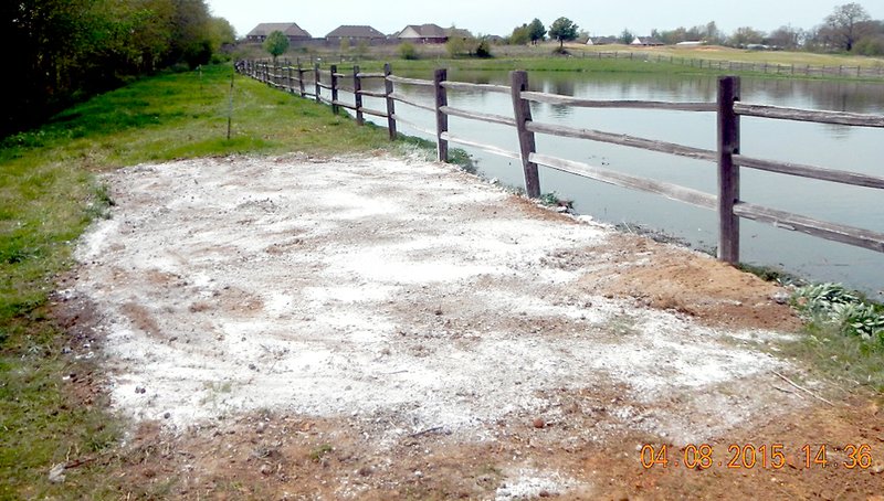 PHOTO/ADEQ This photo by Matt Holden, field inspector with Arkansas Department of Environmental Quality, shows lime applied on the south side of the aeration pond where an overflow had previously occurred. This is the aeration pond for a wastewater treatment facility owned by Washington County Property Owners Improvement District No. 5. The system provides sewer service to Valley View Estates subdivision.