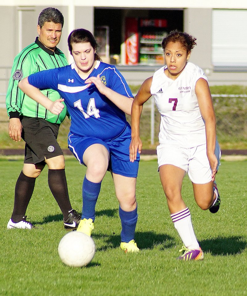 File Photo by Randy Moll LEFT: Dahlia Mendoza (No. 7), who last week signed to play soccer for Ecclesia College, moves the ball down the field for Gentry during play against Bergman on March 31 in Gentry. Last week, the Gentry girls beat the junior varsity team from Rogers Heritage, 4-2 (3-0 at half), with two goals by Amber Ellis and one each for Brieann Ward and Katelyn Williams. Rachel Lawrence was the goalkeeper. The girls were 4-3-1 (3-0 in conference) at the close of the week. On Monday the girls were to travel to play at Fayetteville.