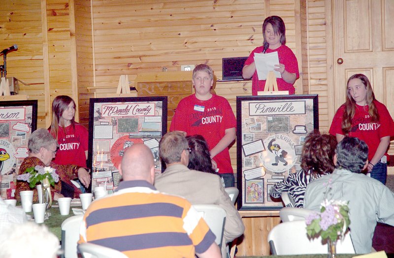 RICK PECK MCDONALD COUNTY PRESS Holly Huber, art teacher at White Rock School, describes panels her students did on the history of all the current schools in the McDonald County School District at a benefit dinner and auction hosted Saturday night by the McDonald County Historical Society.