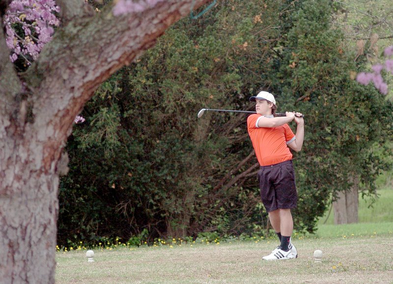 RICK PECK MCDONALD COUNTY PRESS McDonald County senior Kade McKee watches hit tee shot from hole number five at Elk River Golf Course during a match Tuesday with Neosho and Carl Junction.