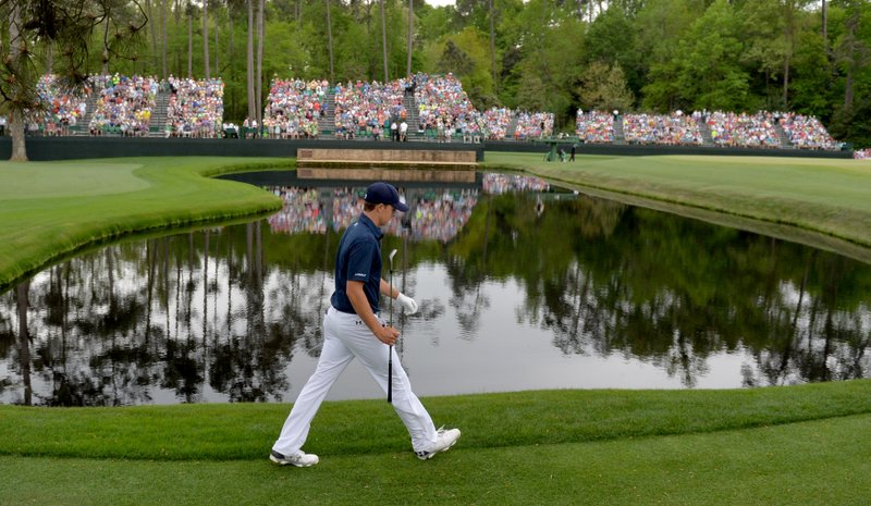 Jordan Spieth walks past the pond at the 15th green in route to winning the 2015 Masters at Augusta National Sunday April 12, 2015, in Augusta, Ga.