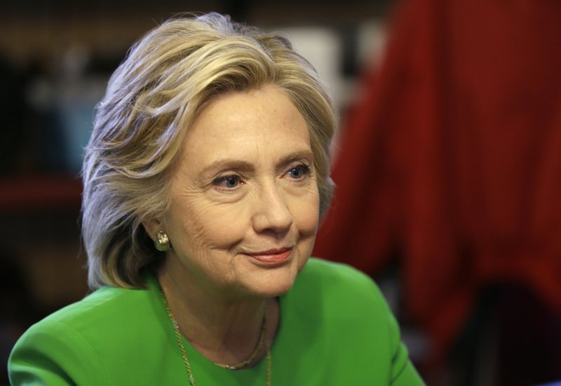 IN this April 14, 2015, photo, Democratic presidential candidate Hillary Rodham Clinton meets with local residents at the Jones St. Java House in LeClaire, Iowa. The board of the Clinton Foundation says it will continue accepting donations from foreign governments but only six nations, a move aimed at insulating presidential candidate Hillary Rodham Clinton from controversies over the charity's reliance on millions of dollars from abroad. 