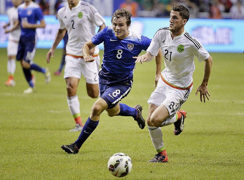 USA defender Jordan Morris (8) chases the ball against Mexico defender Hiram Mier during the first half of an international friendly soccer match, Wednesday, April 15, 2015, in San Antonio.