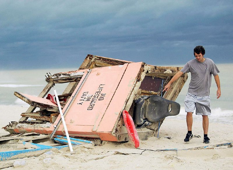 A passerby inspects a Miami Beach, Fla., lifeguard stand toppled by Hurricane Wilma in October 2005. Wilma was the last hurricane to strike the state. 