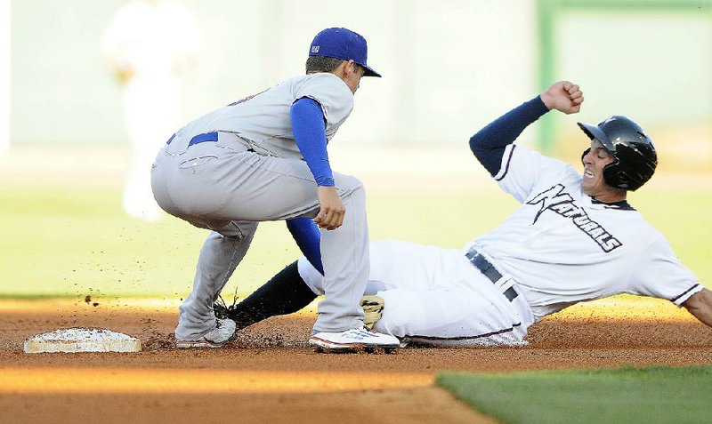 NWA Democrat-Gazette/J.T. WAMPLER -- The Naturals' Lane Adams gets caught at second base by Midland's Chad Pinder Thursday April 16, 2015 at Arvest Ballpark in Springdale.