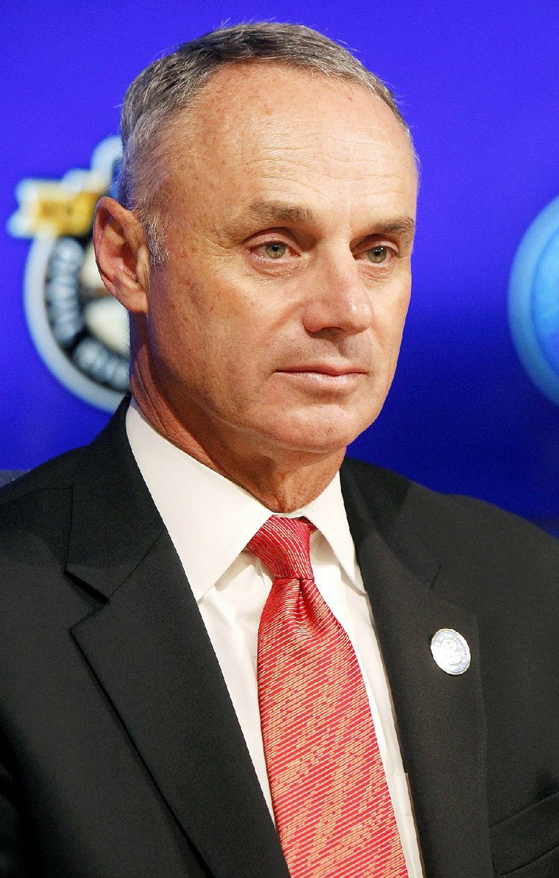 Commissioner of Baseball Rob Manfred listens to a question during a news conference prior to a baseball game between the Los Angeles Dodgers and the Seattle Mariners on Jackie Robinson Day in Los Angeles, Wednesday, April 15, 2015. 