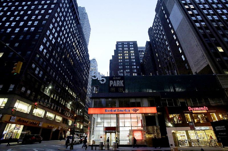 Pedestrians pass a Bank of America branch in New York in January. The bank Wednesday reported a first-quarter profit of $3.4 billion. 