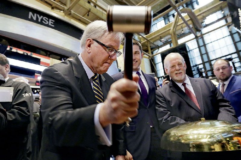 Party City Chief Executive Officer Jim Harrison rings a ceremonial bell to mark the start of trade in Party City stock Thursday on the floor of the New York Stock Exchange. 