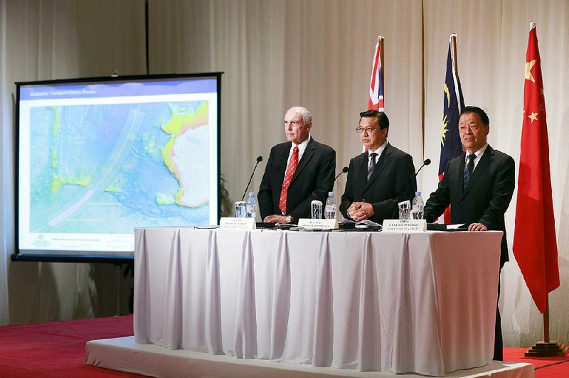 Warren Truss, (left) Liow Tiong Lai and Yang Chuantang, transport ministers from Australia, Malaysia and China, attend a news conference Thursday in Kuala Lumpur where they said they have not given up on finding Malaysia Airlines Flight 370.