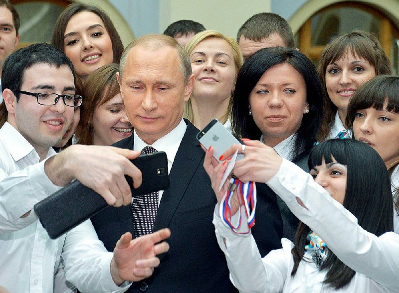 Russian President Vladimir Putin mingles with call-center operators in Moscow after he answered viewers’ questions Thursday on live television. 