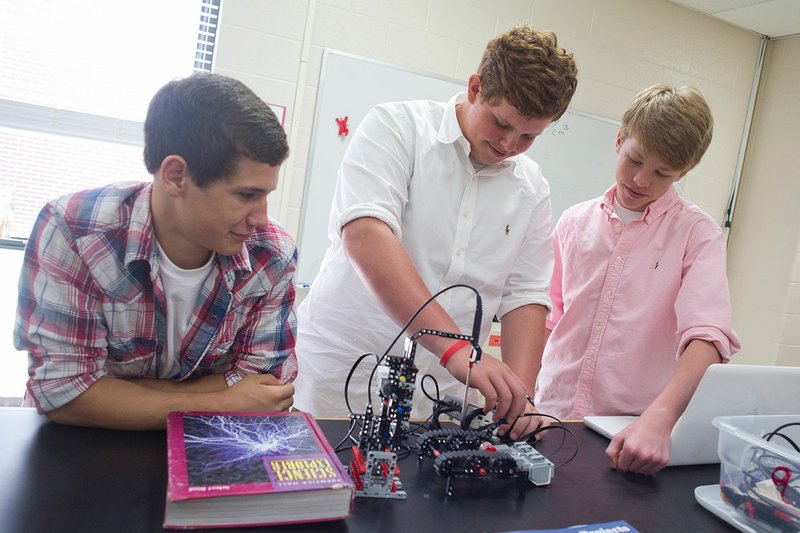 From left, Taylor Boyce, Noah Jolly and Caleb Barrentine built a robot to test the internal temperature of Hot Pockets in their engineering class at Beebe Junior High School. With this project, the students won the 2015 Vernier Engineering Contest.