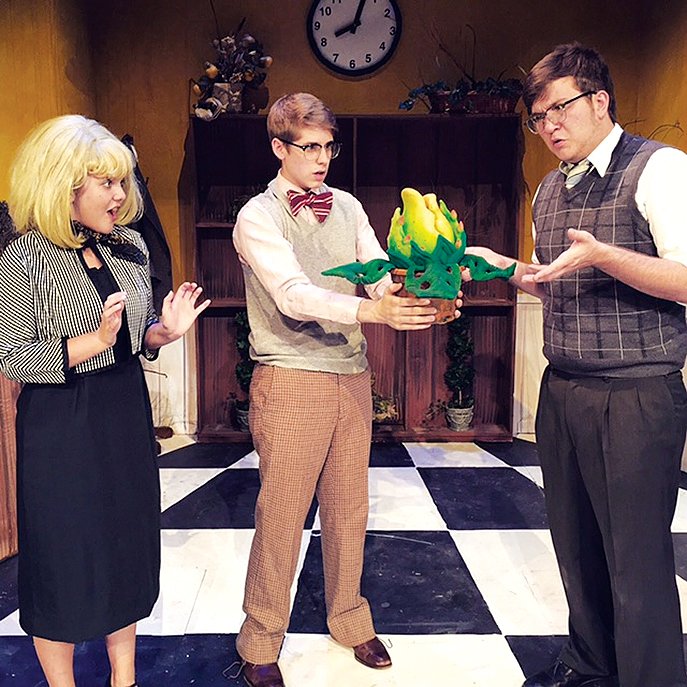 Hannah Villines (from left) is Audrey, Landon Calhoun is Seymour, and Thomas Griffin is Mr. Mushnik in the Fayetteville High School production of “Little Shop of Horrors.”
