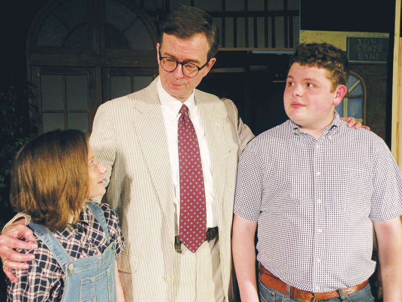 Atticus Finch, played by Harold Dean of North Little Rock, discusses important matters with his children, Scout, left, played by Emily Broach of Benton, and Jem, played by Matthew Glover, also of Benton. These three characters are part of the cast of To Kill a Mockingbird, which will be presented by the Royal Players starting Thursday at the Royal Theatre in downtown Benton.