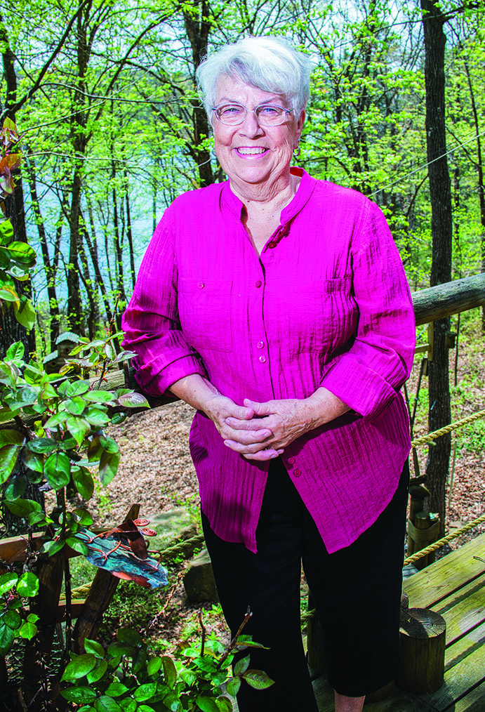 Jean Beisenstein stands on the deck of her home in Tumbling Shoals, where she and her husband moved about 19 years ago from Wisconsin. The 75-year-old Beisenstein has gotten involved in the community, from co-founding the Daisy Patch Quilters Club to becoming a Master Gardener.