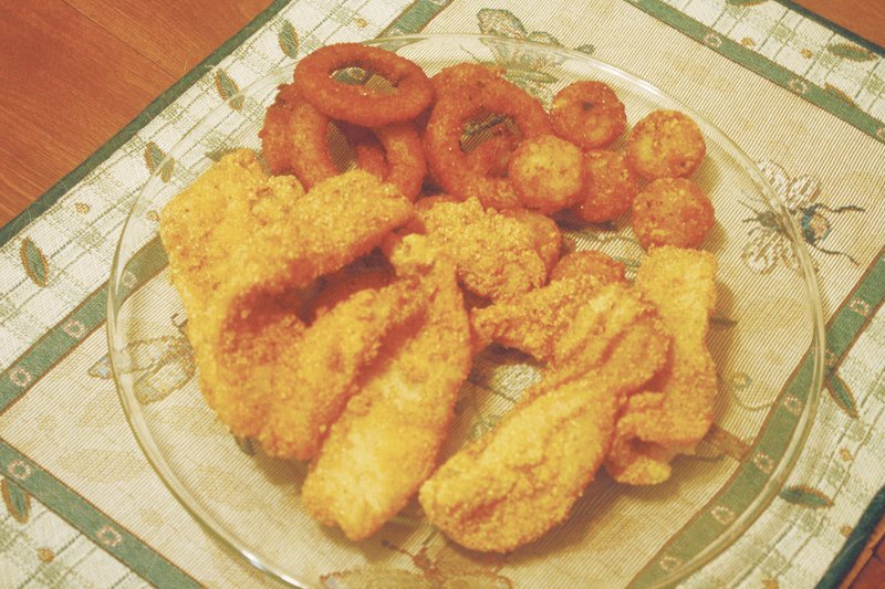 Fried crappie, tater rounds and onion rings await on this dinner plate, rewards of an eventful pursuit of a fish that many anglers hail as one of Arkansas’ most flavorful species.