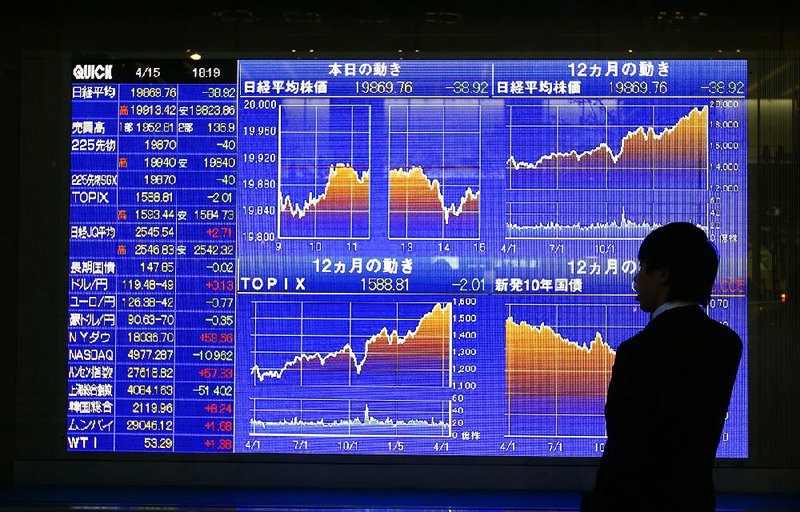 A man looks Wednesday at an electronic stock indicator of a securities firm in Tokyo. Since June 30, the U.S. dollar is up 28 percent against the euro, 18 percent against the Japanese yen and 40 percent against the Brazilian real. 