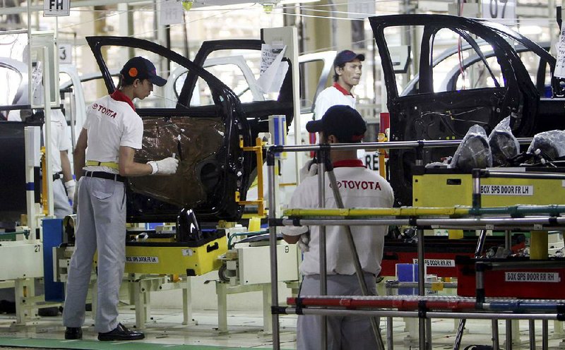 Indonesian workers assemble passenger cars at the new Toyota plant in Karawang, Indonesia, after Toyota officially opened its second manufacturing plant in the country in 2013. 