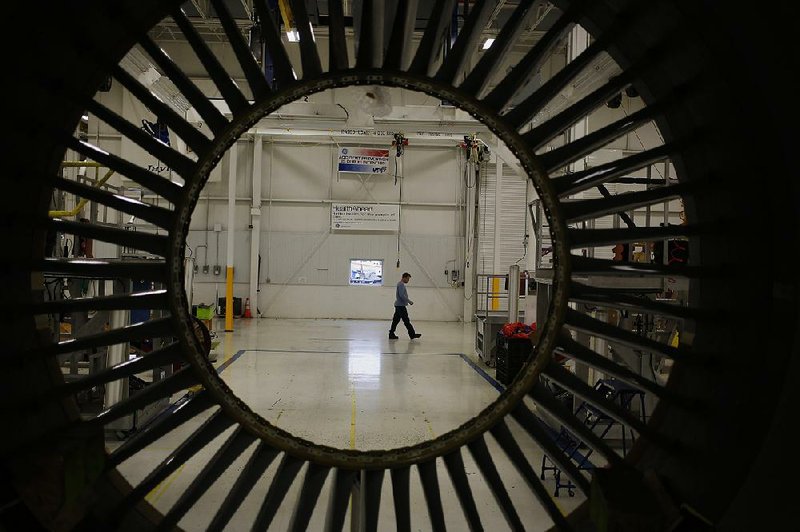 A General Electric employee crosses the factory floor at the GE Aviation Test Operations center in Peebles, Ohio, earlier this week. GE on Friday reported a net first-quarter loss of $13.6 billion. 