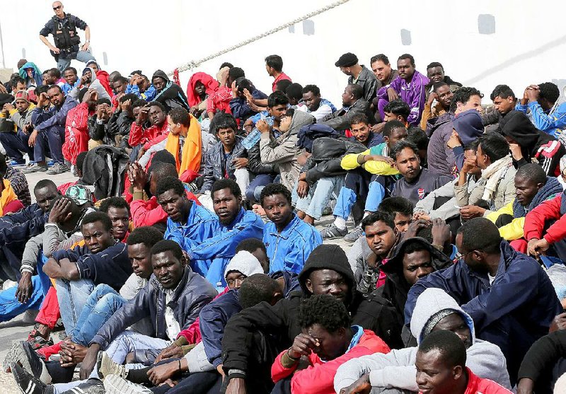 Refugees picked up in Mediterranean waters wait to board a cruise ship Friday on the island of Lampedusa in southern Italy for transfer to a facility in Sicily. The flow of foreigners attempting the risky crossing from Libya to Italy has continued. In a related development Friday, an Italian fishing boat’s crew overcame the seizure of its vessel by armed Libyans in waters where thousands of people have been stranded and rescued. 