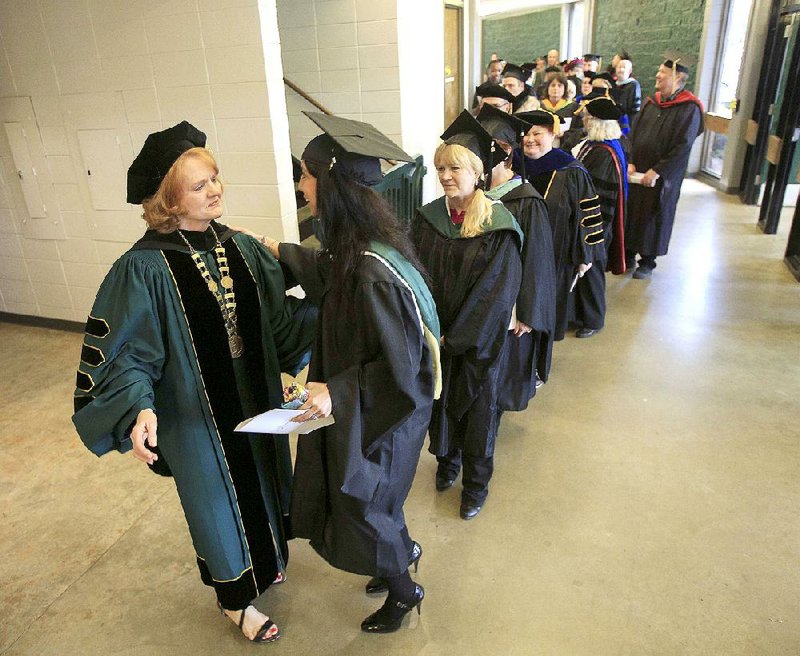 In this May 17, 2015 file photo, Arkansas Tech University President Robin Bowen (left) greets faculty members and friends after her inauguration ceremony in Russellville.