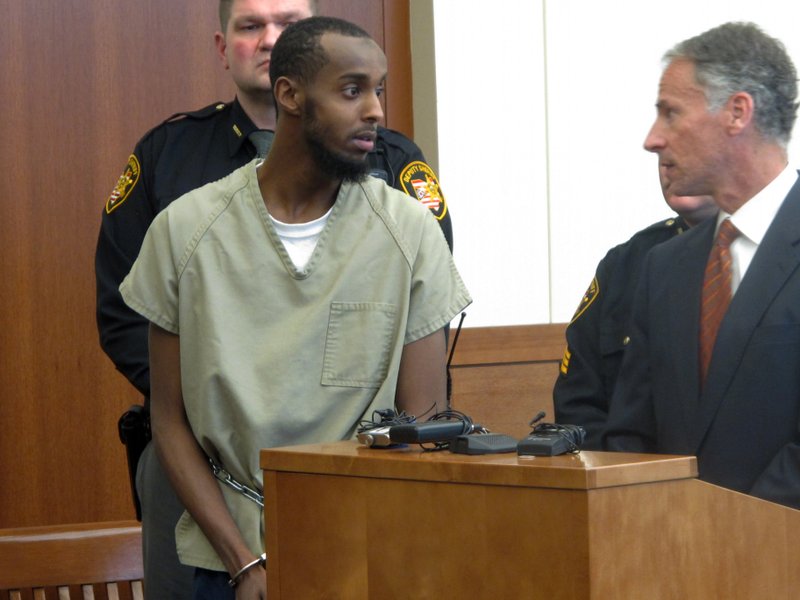  In this Feb. 25, 2015 file photo, Abdirahman Sheik Mohamud, left, speaks with his defense attorney, Sam Shamansky, during a hearing to set bond on charges of money laundering and providing support for terrorism in Columbus, Ohio.  A Thursday, April 16  indictment says Mohamud left the country a year ago to train and fight with terrorists in Syria. The indictment says Mohamud, who was arrested in Columbus earlier this year, weighed which extremist group in Syria was more effective before his travels.