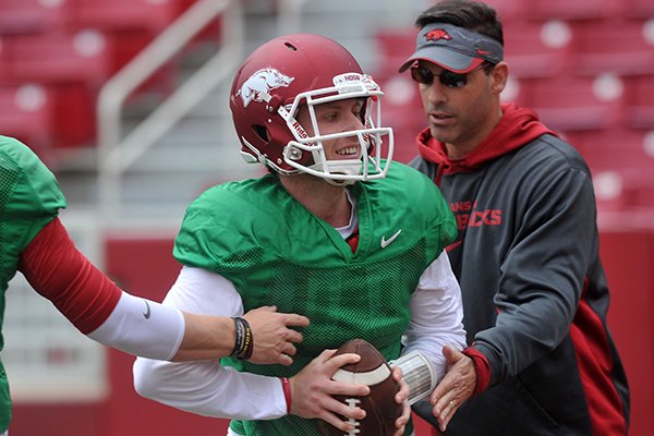 Arkansas quarterback Austin Allen works with offensive coordinator Dan Enos during practice Saturday, April 11, 2015, at Donald W. Reynolds Razorback Stadium in Fayetteville. 