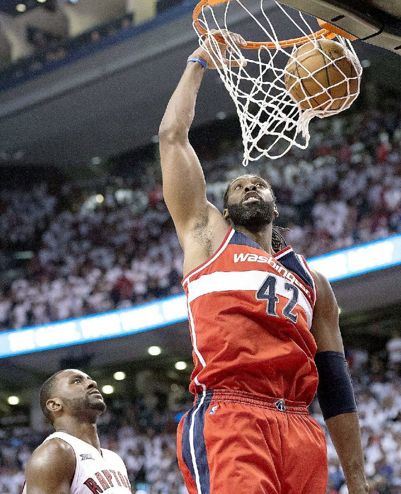 Washington forward Nene scored 12 points and pulled down 13 rebounds to help the Wizards hold off Toronto 93-86 in overtime during the fi rst round of the NBA playoffs on Saturday.