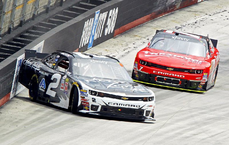 Brian Scott (2) spins off turn four in front of Regan Smith during Saturday’s Xfinity Series race at Bristol Motor Speedway. 