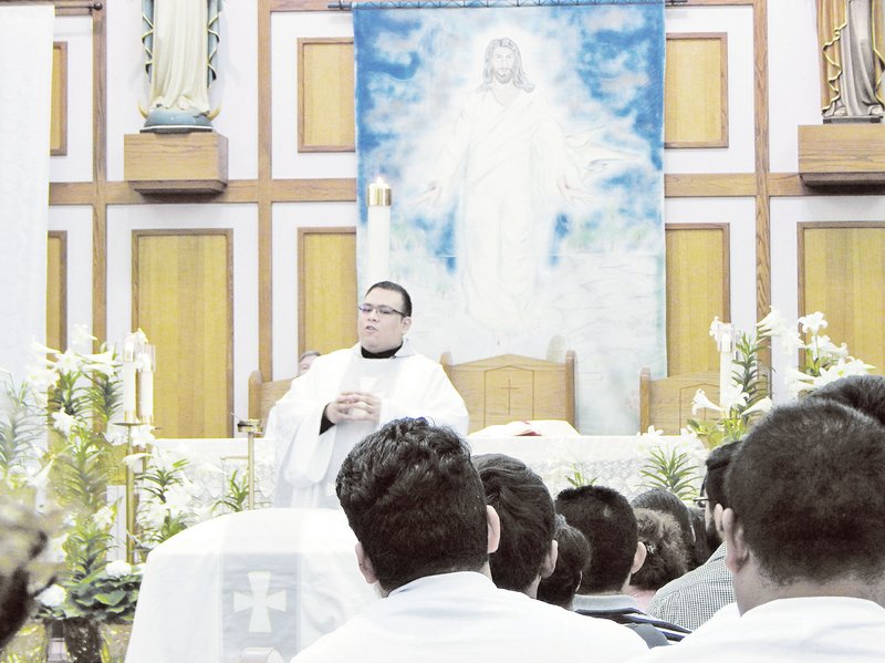 Father Juan Guido, associate pastor at St. Raphael Catholic Church in Springdale, gives a sermon Thursday during the funeral Mass for Jimmy Rodriguez, 20, who was shot on Savage Street in Springdale April 11.