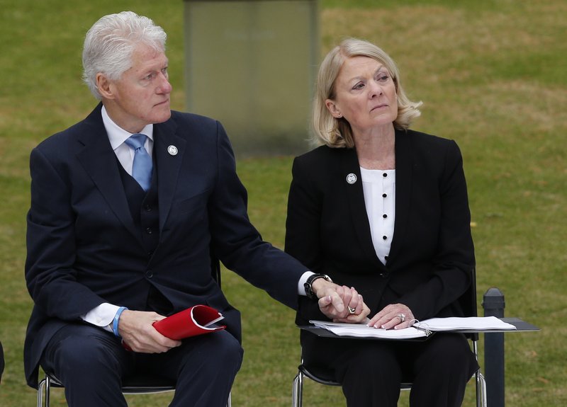 Comforting gesture: Former President Bill Clinton, left, holds the hand of former state Rep. Susan Winchester, right, the chairman of the the Oklahoma City National Memorial Foundations, during a ceremony for the 20th anniversary of the Oklahoma City bombing at the Oklahoma City National Memorial in Oklahoma City, Sunday. Winchester lost her sister Dr. Peggy Clark in the bombing.
