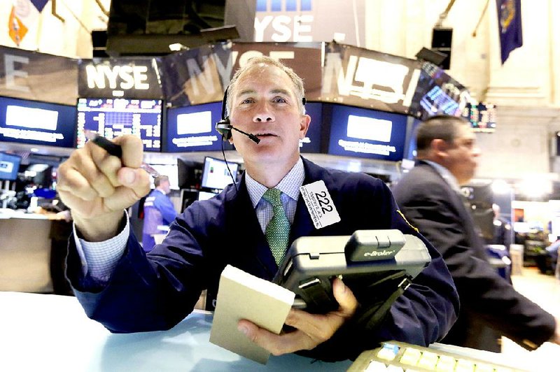 Trader Timothy Nick works on the floor of the New York Stock Exchange, Monday, April 20, 2015. U.S. stocks are opening higher as more big companies turn in healthy financial results for the first quarter of the year. (AP Photo/Richard Drew)