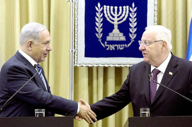 Israeli Prime Minister Benjamin Netanyahu, left, shakes hands with Israeli President Reuven Rivlin, right, during  a brief ceremony in the president's residence, on Monday, April 20, 2015 in Jerusalem.  Netanyahu has received a two-week extension to form a new governing coalition following his election victory last month. (Abir Sultan/Pool Photo via AP)
