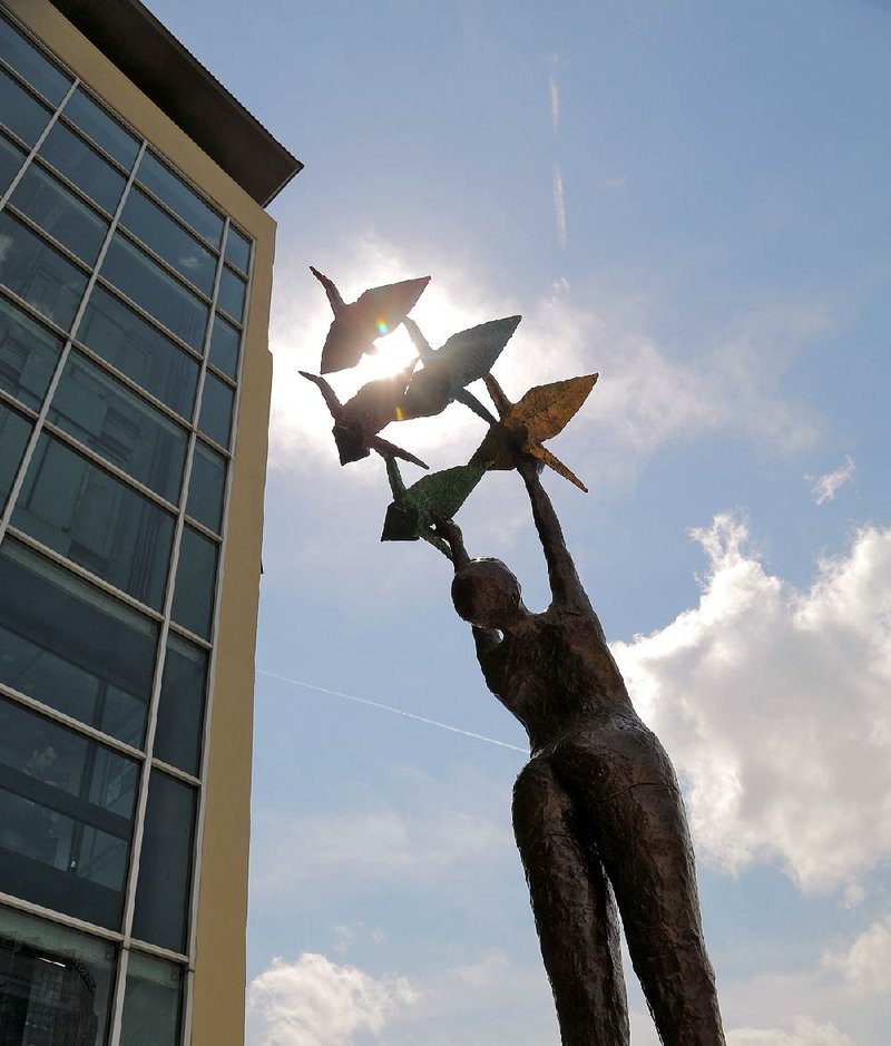 Arkansas Democrat-Gazette/JOHN SYKES JR. - Lorri Acott is a sculptor from Colorado. Her "Peace" sculpture stands at Second and Main Streets in downtown Little Rock and was the winner of the 2014 Sculpture†at the River†Market†Show and Sale. 