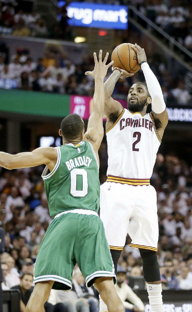 Cleveland Cavaliers' Kyrie Irving (2) shoots over Boston Celtics' Avery Bradley in a first round NBA playoff basketball game Sunday, April 19, 2015, in Cleveland. (AP Photo/Mark Duncan)