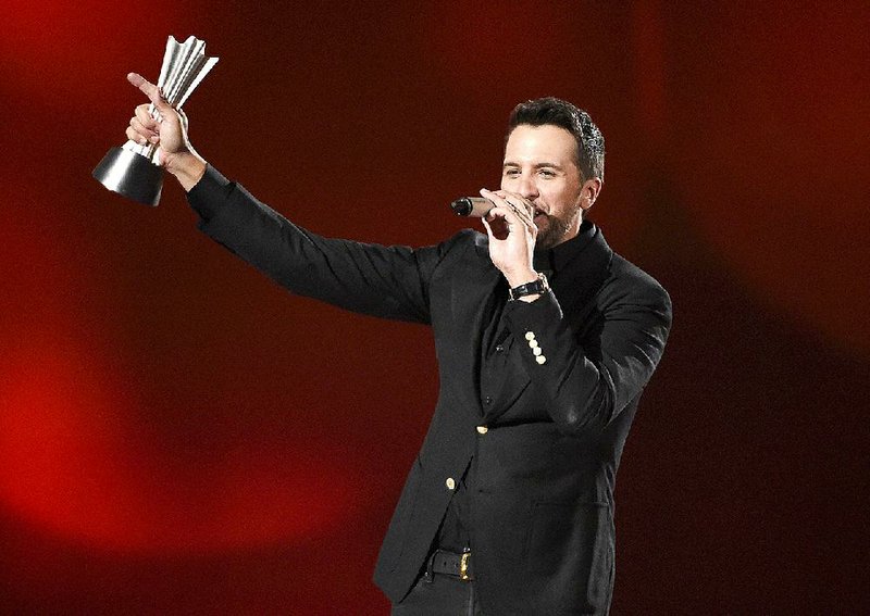 Luke Bryan accepts the award for entertainer of the year at the 50th annual Academy of Country Music Awards at AT&T Stadium on Sunday, April 19, 2015, in Arlington, Texas. (Photo by Chris Pizzello/Invision/AP)