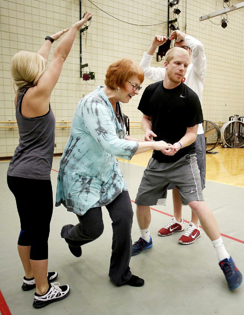 NWA Democrat-Gazette/DAVID GOTTSCHALK - 3/31/15 - Susan W. Mayes, instructor of kinesiology with the department of Health, Human Performance and Recreation at the University of Arkansas, dances with Tyler Haggard, a junior at the University, in the Teaching Education Rhythm and Gymnastics class in Dance Studio 220 of the Health, Physical Education and Recreation building on the campus of the University of Arkansas in Fayetteville Tuesday March 31, 2015. Mayes recently received the 2015 Dance Education of the Year Award for SHAPE  America's Southern District.
