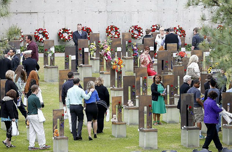 People move into the Field of Empty Chairs , where bombing victims are memorialized, following a ceremony for the 20th anniversary of the Oklahoma City bombing at the Oklahoma City National Memorial in Oklahoma City, Sunday, April 19, 2015. About 1,000 people gathered at the former site of the Oklahoma City federal building to commemorate the 20th anniversary of the terrorist bombing there that killed 168 people and injured many others. (AP Photo/Sue Ogrocki)
