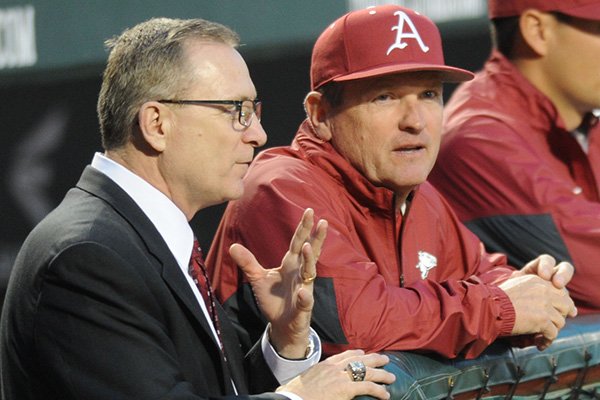 Arkansas coach Dave Van Horn (right) speaks to Jeff Long, director of athletics, while preparing for LSU Friday, March 20, 2015, at Baum Stadium in Fayetteville. 
