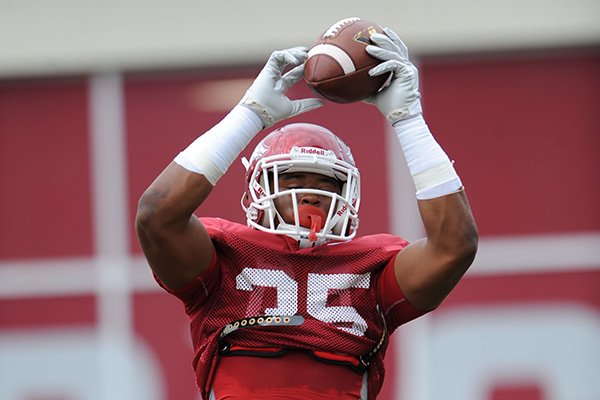 Arkansas freshman linebacker Dwayne Eugene catches a ball during practice Saturday, Aug. 16, 2014, at Razorback Stadium in Fayetteville.