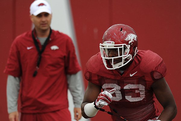 Jeremy Sprinkle of Arkansas works through a drill during practice Saturday, April 18, 2015, at the university's practice facility in Fayetteville.
