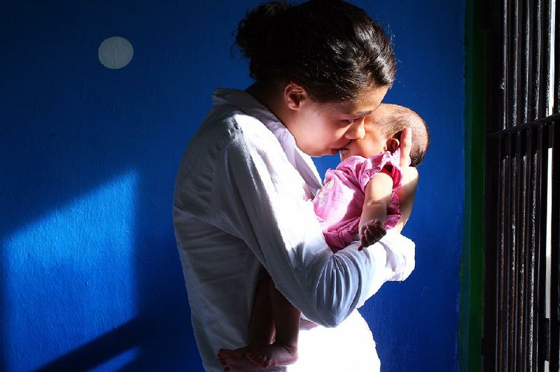 Heather Mack, 19, holds her baby daughter, Stella, inside a jail cell after hearing her guilty verdict Tuesday in Bali, Indonesia, in the murder of her mother. Mack was sentenced to 10 years in prison. 