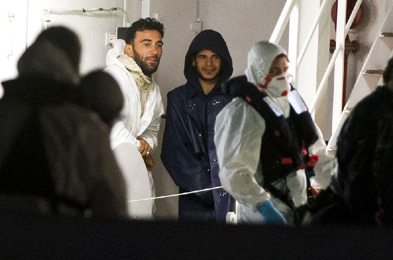 Mohammed Ali Malek (left), identified by prosecutors as captain of the trawler that sank with hundreds of people aboard, and Mahmud Bihkit (center), the navigator, are facing charges, officials said Tuesday. 