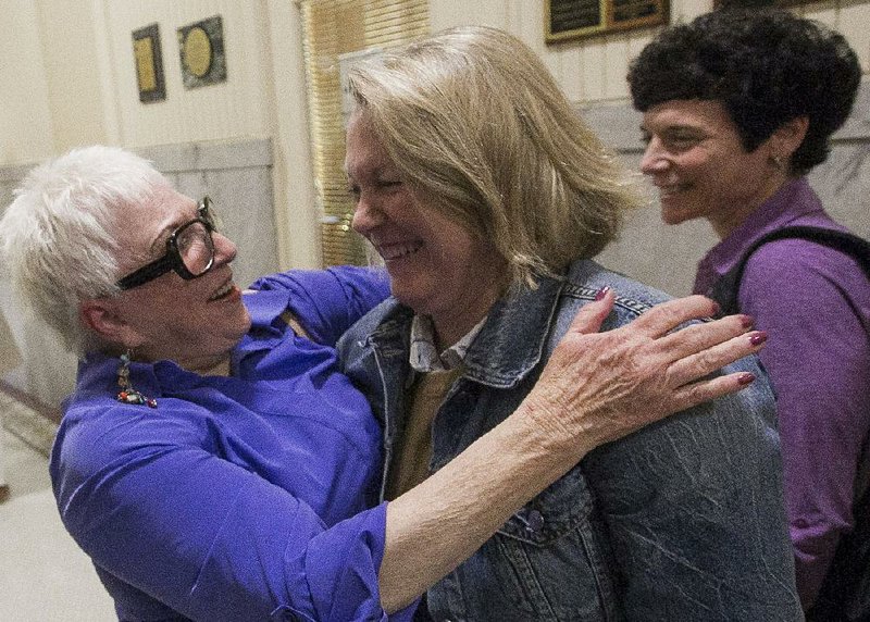 Rebecca Cowling (from left) celebrates Tuesday with Tippi McCullough, president of the Arkansas Stonewall Democratic Caucus, and Barbara Mariani, vice president of the group, after the city board’s vote. 