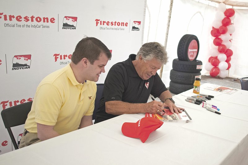 State Rep. James Sturch, left, gets an autograph from Mario Andretti at Southern Tire Mart’s customer appreciation event April 16. Southern Tire Mart is a Firestone dealer and Andretti is still associated with the brand, even in retirement. The Bateville company planned the event with Firestone’s help.