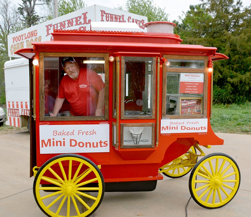 Janelle Jessen/Herald-Leader Jerry Carston inside the stagecoach he restored for the Dogwood Festival. The stagecoach was build as a popcorn trailer for his step-father 30 years ago. Carston plans to use it to sell mini donuts and popcorn.