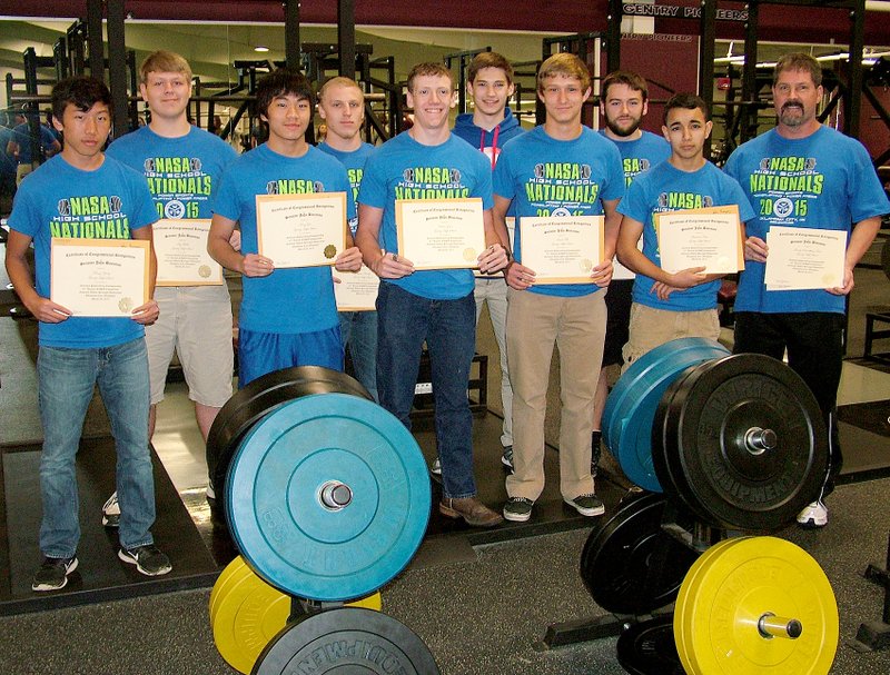 Photo by Randy Moll Power lifters pictured with certificates from Senator Boozman&#8217;s office are: Khang Yang, Trey Welch, Kong Lor, Trystan Handy, Keeton Jones, Bryan Harris, James Fell, Kaven Flesner, Lawrence Caro and Coach Sean Seligman. Kathryn Gough, Senator Boozman&#8217;s representative, and Gentry Major Kevin Johnston were at Gentry High School on April 14 to present the Gentry High School powerlifting team with congressional certificates of recognition from Senator John Boozman for the team&#8217;s national championship. The Gentry powerlifting team (an unsanctioned sport in Arkansas) competed in the 31st annual Natural Athlete Strength Association High School National Powerlifting Championships in Oklahoma City, Okla., on March 28, with nine lifters competing in powersports and unequipped bench press. The Gentry athletes won a team national championship, with five bench press national champions and two runners up. Gentry is the first high school powerlifting team to win a national championship in the state of Arkansas.