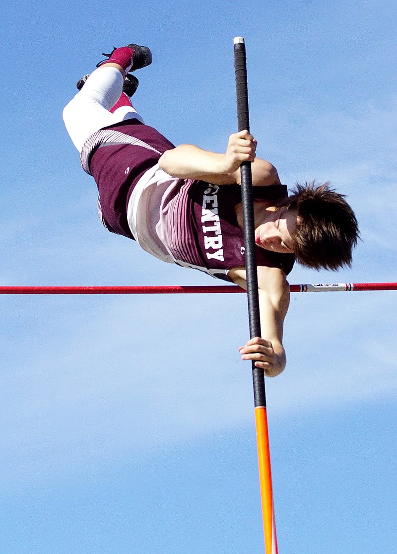 Photo by Randy Moll Cole Cripps, Gentry sophomore, pushes himself over the bar during the pole vaulting competition at the Pioneer Relays on Thursday. Not only did Cripps win the event, he accomplished a personal best and broke the school&#8217;s record when he cleared 13 feet, 5 inches.